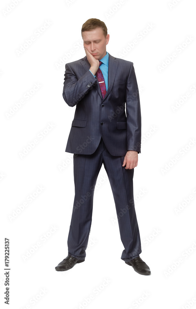 A man in a suit stands and holds his hand to his chin and feeling a toothache isoalted on white background. A man in a suit stands and holds his hand to his chin and feeling a toothache isoalted on white background.