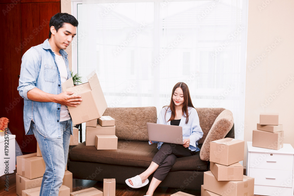 Young couple with cardboard box at home - Business online and delivery concept Young couple with cardboard box at home - Business online and delivery concept