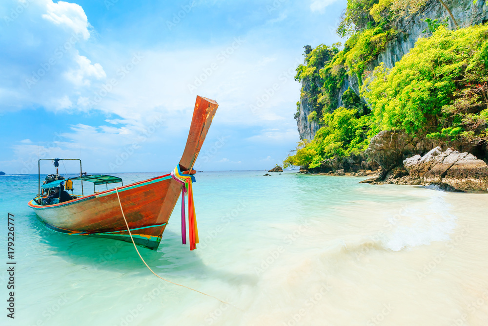 Longtale boat on the white beach at Phuket, Thailand. Phuket is a popular destination famous for its beaches. Longtale boat on the white beach at Phuket, Thailand. Phuket is a popular destination famous for its beaches.