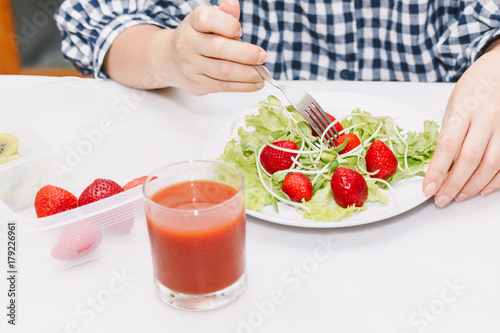 Woman eating fruit and vegetables in the kitchen.healthy lifestyle concept