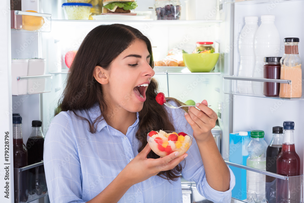 Woman Eating Fruits In Bowl