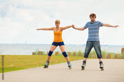 Young couple on roller skates riding outdoors © anetlanda