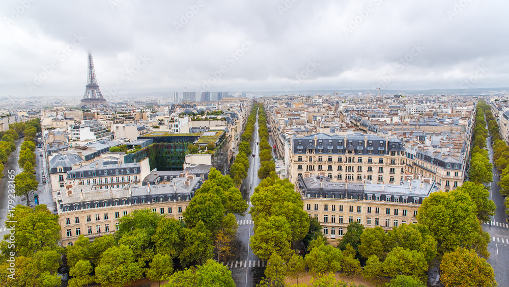 Paris, panorama from Arc de Triomphe, buildings, avenues and the Eiffel tower in background 
