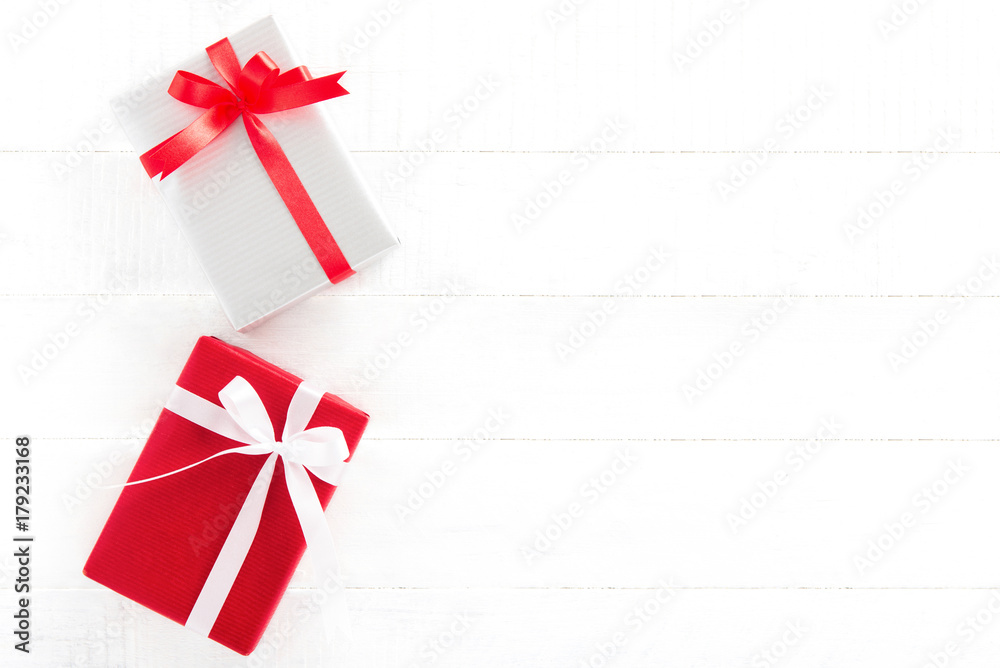 Gift boxes on white wood background, top view, border design