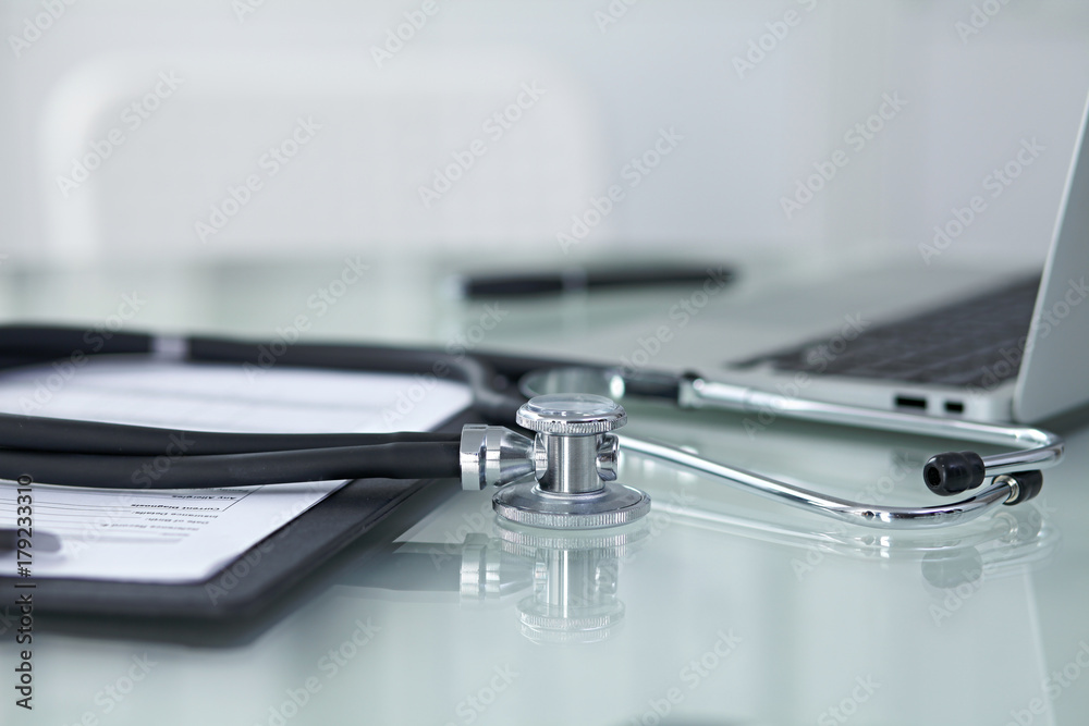 Medicine doctor's working table. Focus on stethoscope Medicine doctor's working table. Focus on stethoscope