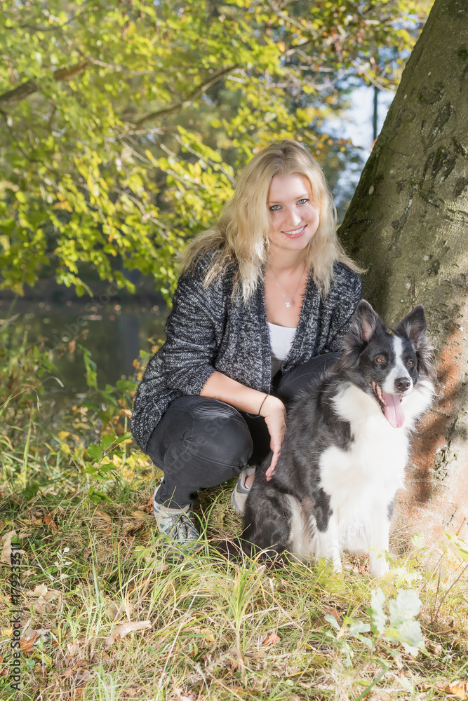 Portrait of smiling young woman with her dog Portrait of smiling young woman with her dog