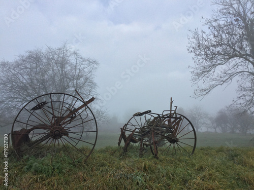 Vintage farm machinery in fog