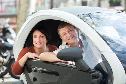 Couple standing near twizy electric photo