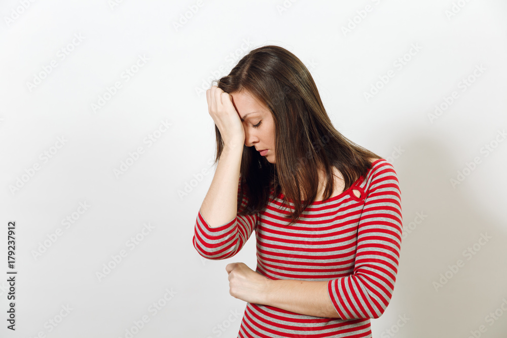 Pretty European worried and pensive brown-haired woman with healthy clean skin and headache, dressed in red and grey clothes lost in thought and conjectures, on a white background. Emotions concept. Pretty European worried and pensive brown-haired woman with healthy clean skin and headache, dressed in red and grey clothes lost in thought and conjectures, on a white background. Emotions concept.