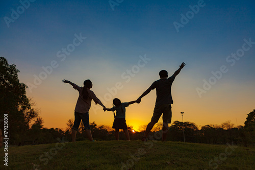 Family silhouette with sunset.