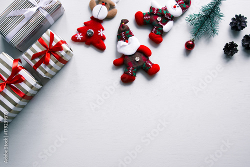 New year's background on a white desk decorated with toys, presents, Santa Claus, snowman. Bright colored background symbolizes the new year celebration. Great useful template to wright words down.