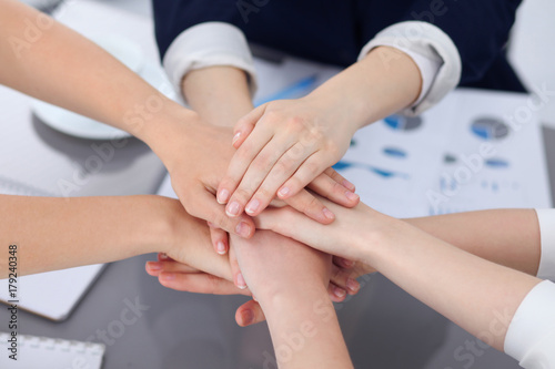 Unknown business people joining hands  close-up. Teamwork concept