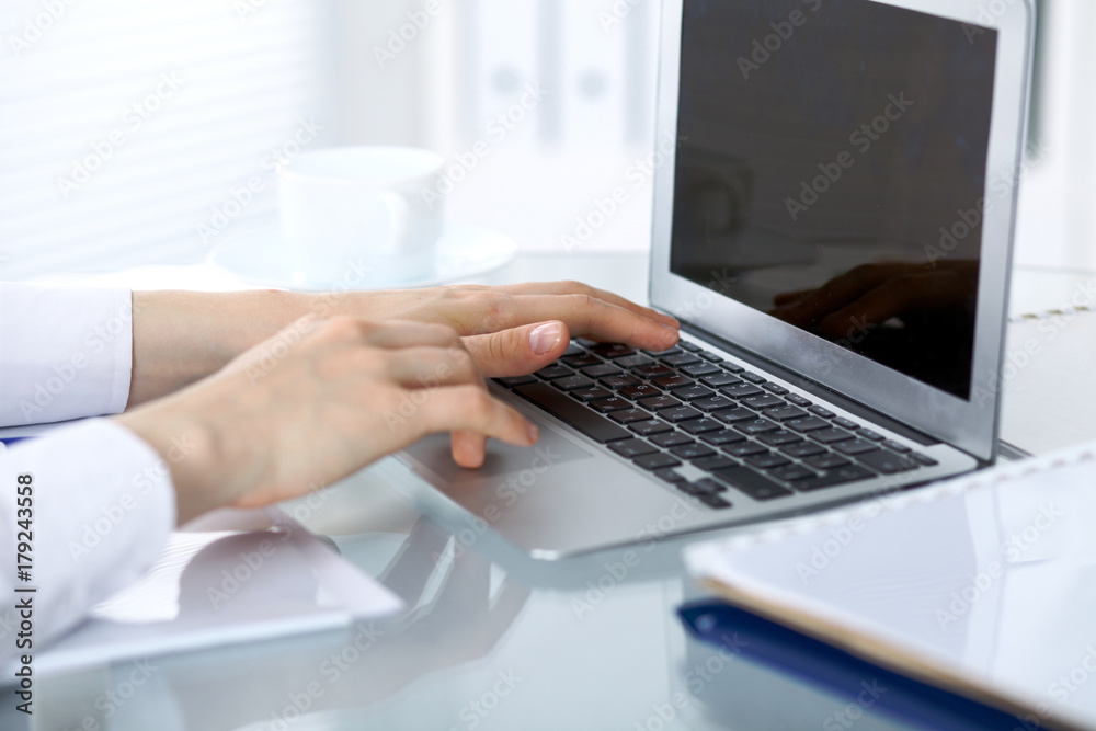 Close up of business woman hands typing on laptop computer Close up of business woman hands typing on laptop computer
