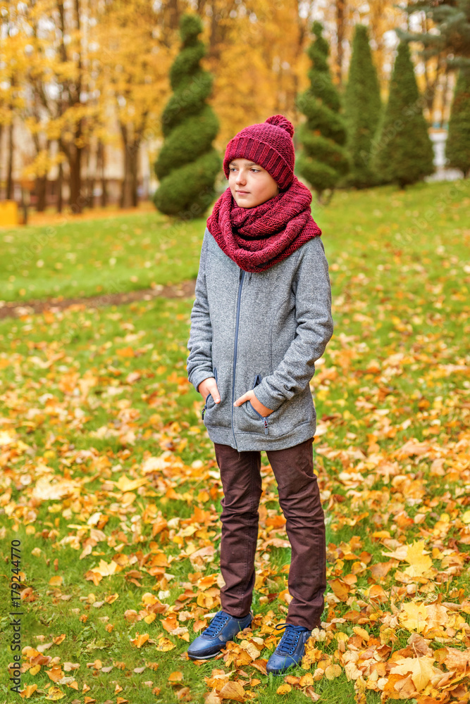 the guy is standing in a claret red scarf and hat the guy is standing in a claret red scarf and hat