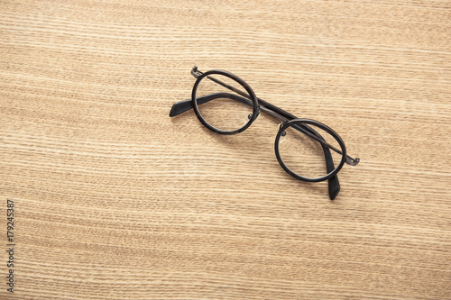 black glasses on the wood table at the daylight.