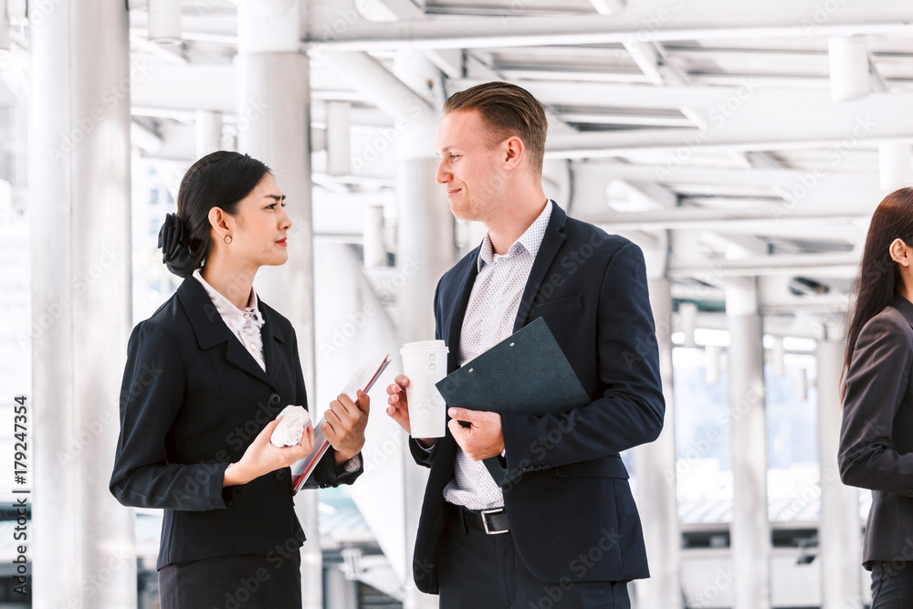 Image two business partners talking and working together Image two business partners talking and working together