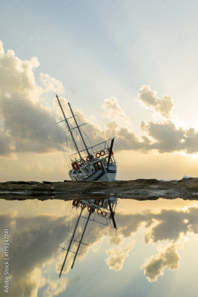 Wrecked boat abandoned stand on beach in RHodes Greece