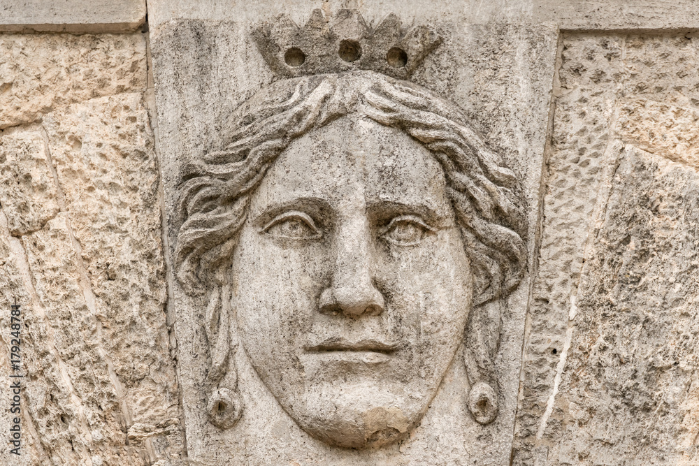 Stone bas-relief with the face of the queen