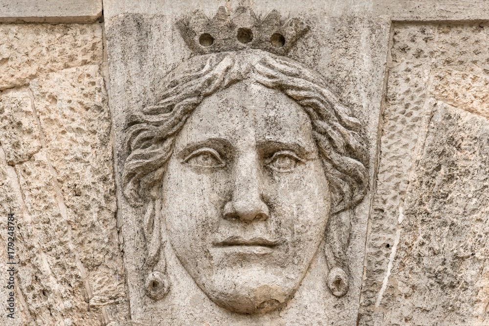 Stone bas-relief with the face of the queen Stone bas-relief with the face of the queen