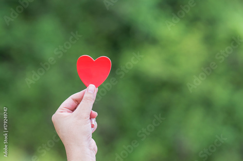 Red heart in the woman hand