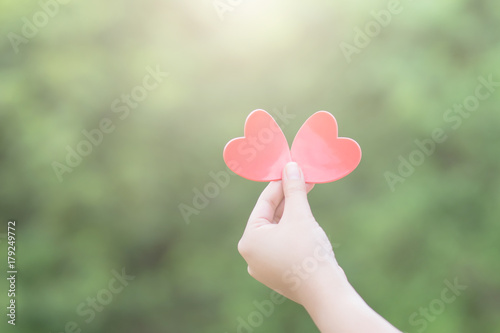 Red heart in the woman hand