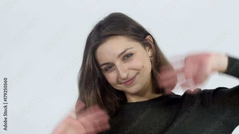 A girl waving her hand saying hello A girl waving her hand saying hello