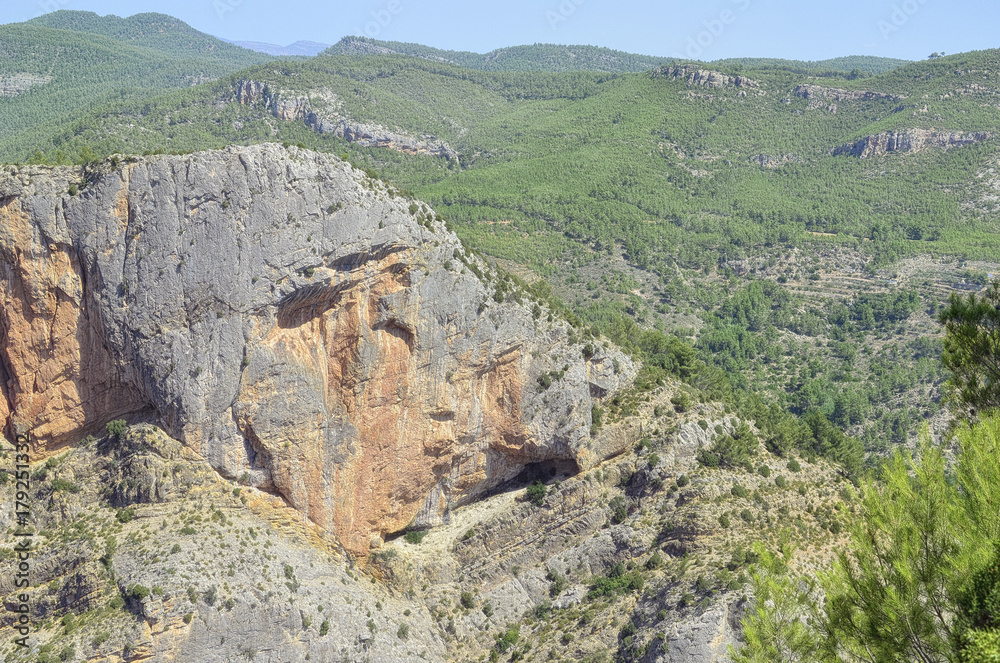 Natural and beautiful landscape. Panorama since the hiking trail area of La Bojera, in Montanejos (Castellon - Spain). Climbing zone. Glorious sunny day of summertime. Mountain of limestone rock. Natural and beautiful landscape. Panorama since the hiking trail area of La Bojera, in Montanejos (Castellon - Spain). Climbing zone. Glorious sunny day of summertime. Mountain of limestone rock.