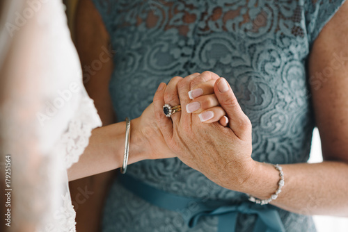 mother holds her hand to her daughter before the wedding