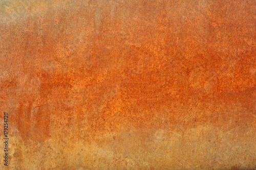 Orange brown old rusted corroded metal or steel sheet horizontal wall background as abstract dirty textured metallic vintage industrial closeup for retro grungy surface design. A rough iron aged plate