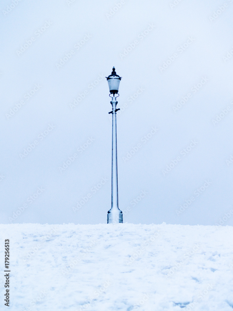 Snow covered lamp post on Primrose Hill in London, UK