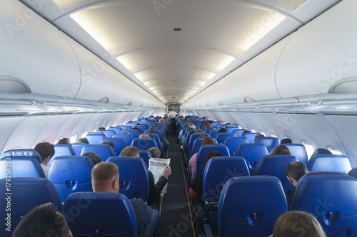 Interior of airplane with passengers on seats. photo