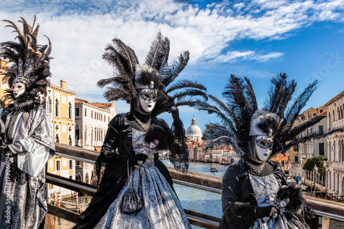 Carnival masks on bridge against Grand Canal in Venice, Italy
