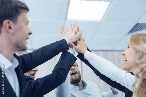 Delighted businesspeople touching hands