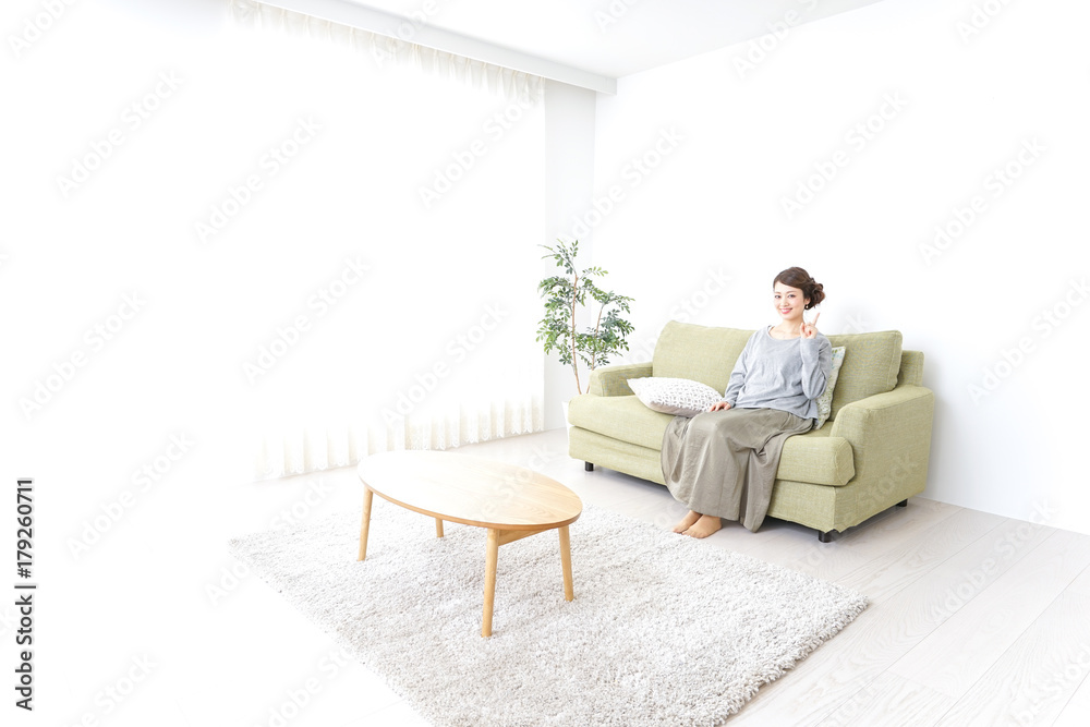 Woman pointing to something at home Woman pointing to something at home