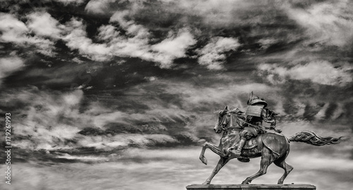 Kusunoki Masashige samurai bronze equestrian statue erected in 1897 in the center of Tokyo, against beautiful sky with clouds (Black and White) photo