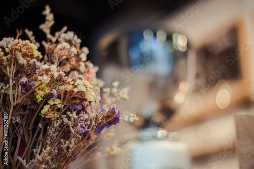 foreground of dry flower in jar at cafe