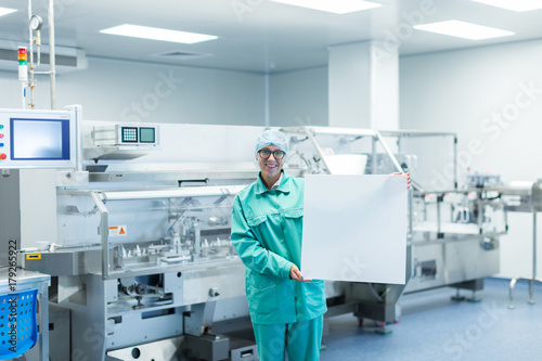 pharmaceutical factory worker shows Equipment