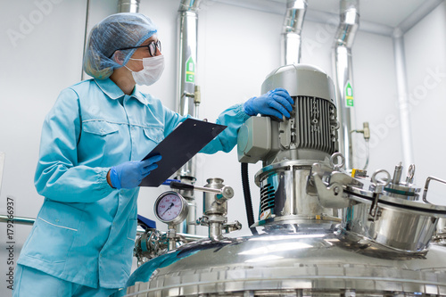 scientist monitors the readings on the equipment