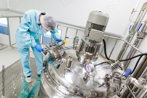 scientist is working with steel tanks photo