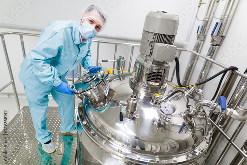 scientist is working with steel tanks