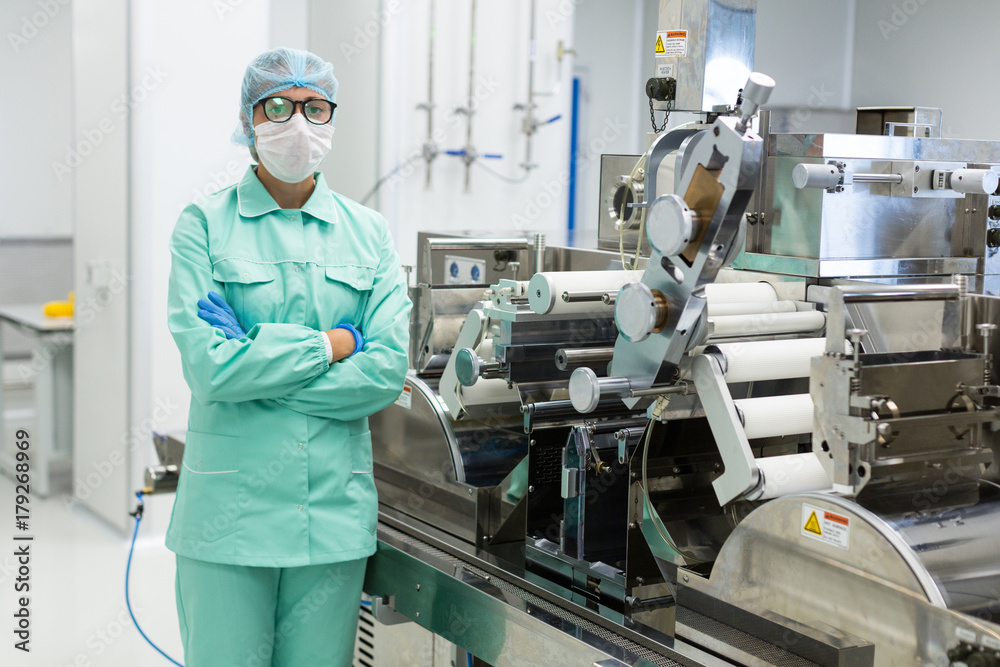 scientist is standing near machine with shafts scientist is standing near machine with shafts