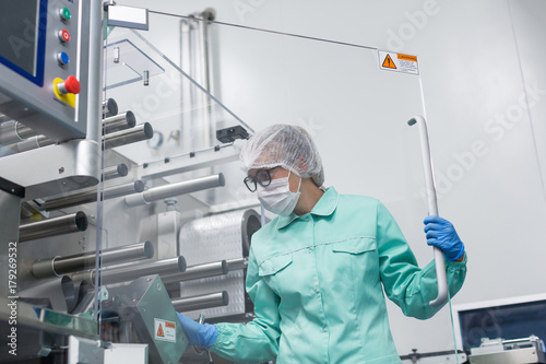 factory worker work with machine photo