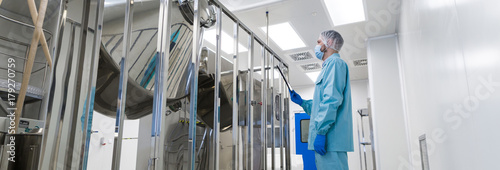 scientist stand near chromed barrels photo