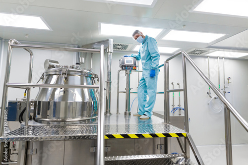 scientist look in steel tank in laboratory photo