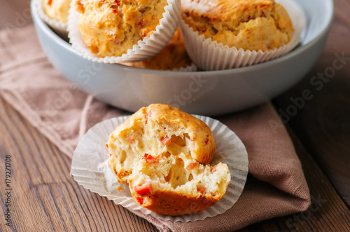 Homemade muffins with bacon and cheese in a gray plate. Healthy snack or breakfast meal. Wooden background.