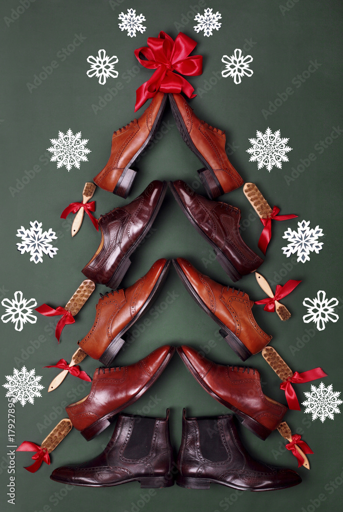 Christmas tree made from classic polished oxfords brogues shoes on green  leather background. Creative christmas tree. Christmas sales .Shoes shop  christmas.Top view.Snow flakes on bacground Stock Photo | Adobe Stock