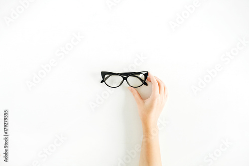 Glasses in woman hand. Minimal flat lay, top view.