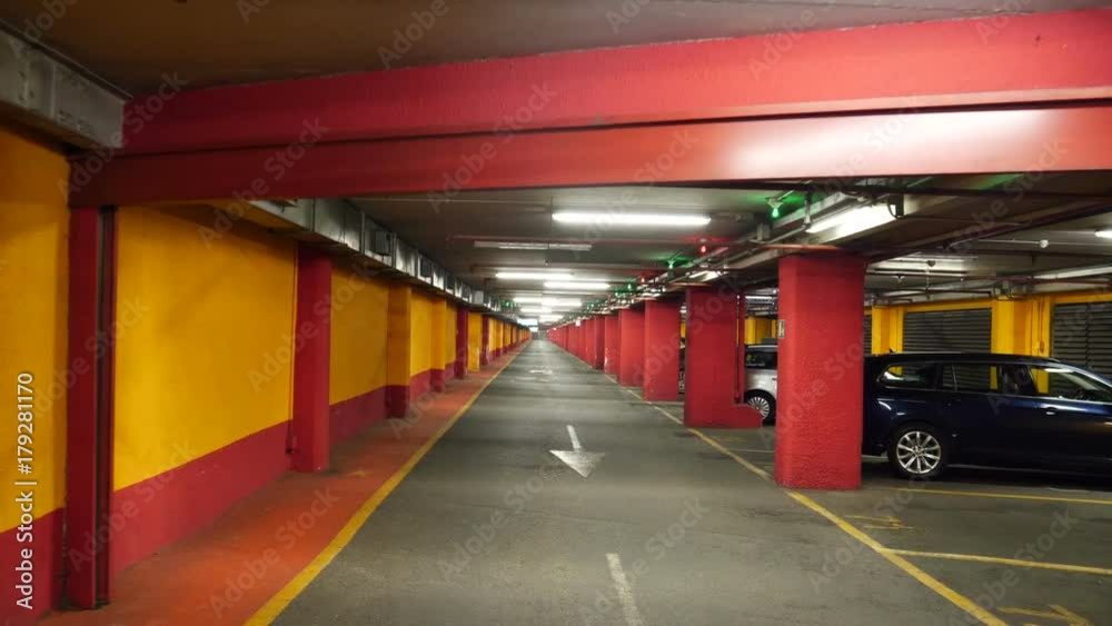 Half empty underground garage or parking. Cameraman walking along the path