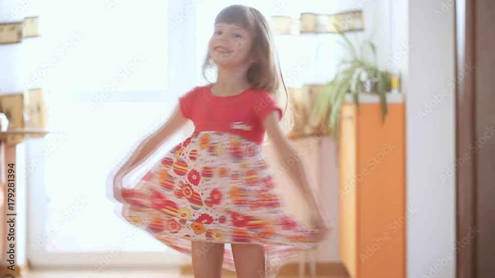 Little girl is spinning around inside the house Little girl is spinning around inside the house