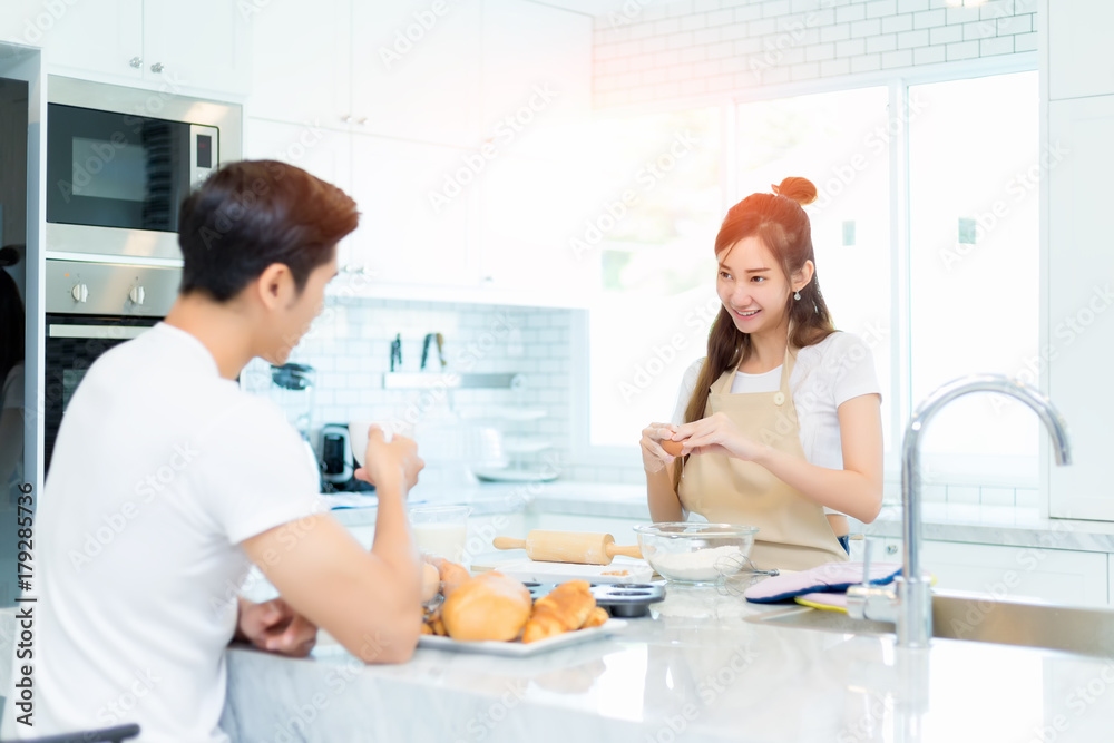 Asian couple cooking for bakery for romantic diner in kitchen room in the home. Asian couple cooking for bakery for romantic diner in kitchen room in the home.